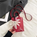 Chic red faux leather tote bag with white floral charm and adjustable shoulder strap - Red with Pendant