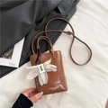Brown leather tote bag with elegant flower charm and adjustable shoulder strap - Brown with Pendant