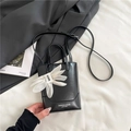 Chic black leather tote bag with a white floral charm and adjustable shoulder strap - Black With Pendant