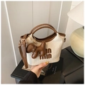 Chic beige woven straw bucket bag with brown leather handles and a cute puppy charm - Brown with Pendant