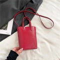 Minimalist small red tote bag in glossy leather finish with adjustable crossbody strap - Red (No Pendant)