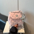 Close-up of pink quilted patent leather mini bag with sparkling rhinestones and silver star - Pink With Pendant