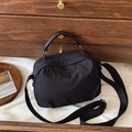 Minimalist black nylon handbag with adjustable strap and premium leather top handles - Black