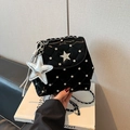 Detail of glossy quilted black bag featuring rhinestone star logo and silver chain strap - Black With Pendant
