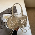 Detailed view of the cream PU leather handbag with elegant bow and polka dot scarf handle - Off-white
