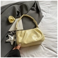 Detail of pale yellow pleated leather bag with woven handle and silver star balloon dog charms - With Pendant / Yellow