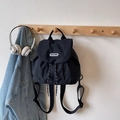 Minimalist black nylon drawstring backpack with brand label for casual outdoor travel - Black / Small