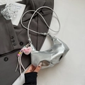 Close-up of metallic silver crescent bag with pink heart plush Barbie Girl charm accessory - Silver with Charm