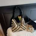 Detail of checkered woven tote bag with pleated leather handle and decorative tulip flower - Black