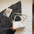 White lychee pattern leather crossbody bag with knot handle on grey blazer - White Without Pendant