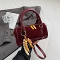 Deep red suede Boston bag with leather trim and wooden bead charm accessory - Red with Pendant