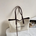 Detail view of large canvas tote bag with brown leather handles and Paris print - White & Coffee