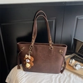 Detail of a brown PU leather tote bag with logo and a cute teddy bear charm - With Pendant / Brown