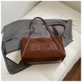 Retro brown suede tote bag with MOACHI lettering on a grey blazer suit backdrop - Coffee without Pendant