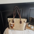 Detail view of cream PU leather tote bag with brown bear keychain and side drawstring - With Pendant / Off White
