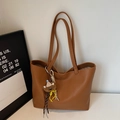Detail of tan pebble grain faux leather tote bag with a cute bear plush charm - Yellow Brown With Charm