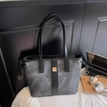 Detail view of marble pattern fabric tote with leather straps and gold metal buckle - Black