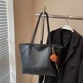 Large black faux leather tote bag with gold lettering and a brown plush bear charm - Black with Pendant