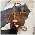 Detail of lychee pattern leather tote bag in light brown with cute bear plush charm - With Charm / Khaki