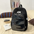 Minimalist black student backpack with transparent PVC display pocket in a bedroom setting - Black Without Doll