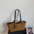 Detail of a brown suede tote bag with leather trim and adjustable shoulder straps - Brown