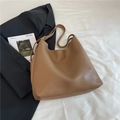 Brown lychee leather hobo tote bag with gold buckle on white fabric background - Khaki