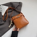 Brown litchi grain crossbody bag with gold buckle and ethnic beaded charm detail - With Pendant / Yellow Brown