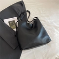 Classic black bucket bag in premium lychee pattern leather for a stylish commuter look - Black