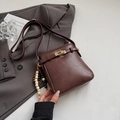 Brown litchi texture crossbody bucket bag with beaded charm and gold hardware - With Pendant / Coffee