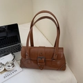 Detail of vintage brown leather bag with rivets, buckle and thin shoulder straps - Brown