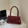 Detail view of burgundy retro shoulder bag with silver rivets and buckle closure - Burgundy