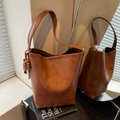 Brown vintage faux leather bucket bag with wide strap and colorful wooden bead charm - With Charm / Brown