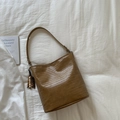 Dark brown woven bucket bag featuring detailed texture and decorative wooden bead tassel - Khaki