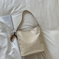 Chic cream woven bucket bag with elegant wooden bead charm and minimalist leather texture - Off White