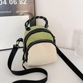 Mini shell backpack in avocado green and beige with braided handle and adjustable straps - Color Block