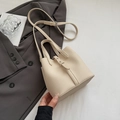 Minimalist beige bucket bag with lychee texture, featuring adjustable straps for women - Rice White (No Pendant)