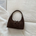 Minimalist dark brown suede hobo bag with top zipper on white textured background - Brown
