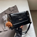 Chic black tote bag with gold hardware and a cute teddy bear charm on white fabric - Black with Pendant