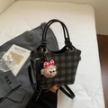 Fashionable grey checkered bucket bag with cute plush bear charm on white bedding - Black