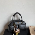 Close-up of black Boston bag featuring dual front pockets and cute bear head charm - Black with Pendant