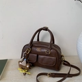 Detail of dark brown matte PU leather Boston bag with bear charm and front pockets - Coffee with Pendant