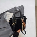 Petit sac seau en daim noir avec motifs d'étoiles et charm perlé sur fond de blazer gris - Noir (Avec Pendentif)