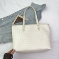 Chic beige woven tote bag with large capacity and elegant gold metal rivet details - Off White