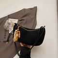 Detail of black crescent shoulder bag with colorful retro wooden bead charms on coat - Black With Pendant