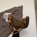 Detail of suede crescent bag with olive knot handle and colorful wooden beads - Green with Charm
