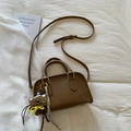 Brown vintage faux leather crossbody bag with teddy bear charm on white fabric - Brown with Pendant