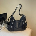Large black faux leather tote bag with silver zippers and long fringe tassels - Black