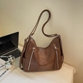 Brown vintage faux leather tote bag with silver zippers and stylish long tassels - Caramel color