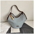 Detail of blue textured fabric tote with brown leather straps and wooden bead charm - Light Blue With Pendant