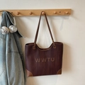 Brown woven leather tote bag with WWTU lettering hanging on wooden stand - No Pendant / Brown